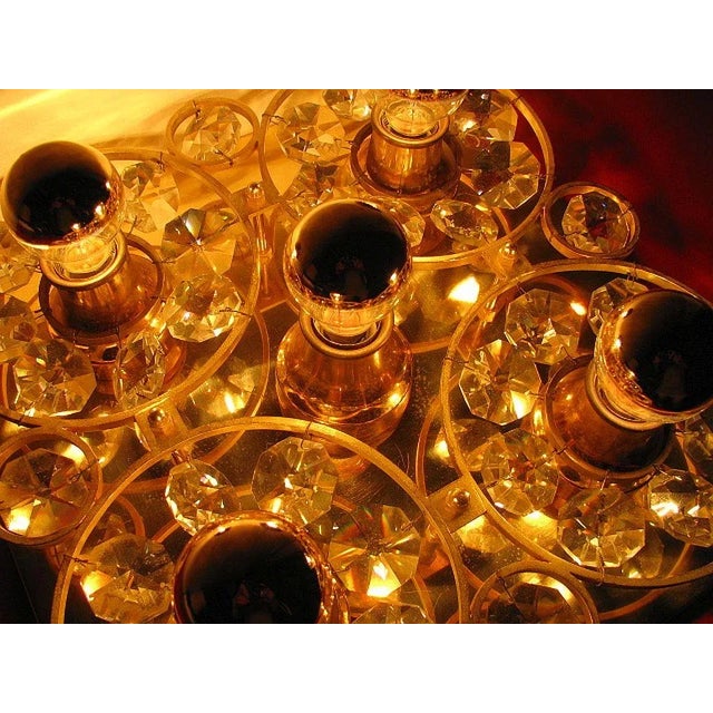 Gold wall lamp. Glass crystals, 1960s. Lamp for 5 E14 bulbs. Dimensions: 31 cm x 31 cm x 8 cm. European Plug (up to...