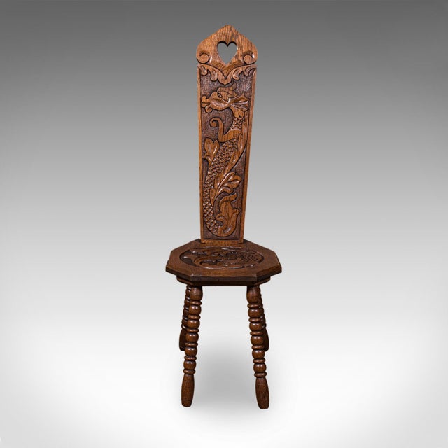 This is an antique Pembrokeshire spinning chair. A Welsh, carved oak work stool, dating to the Victorian period, circa...