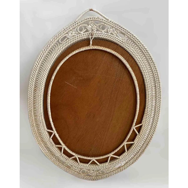 Vintage classic white oval wicker framed mirror. Paint is a little distressed.