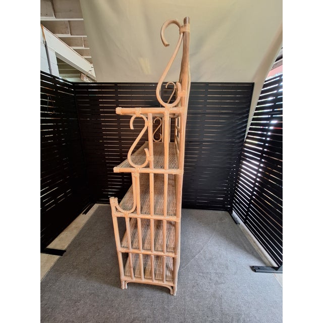 The baker's rack features both bent rattan and woven shelves with two glass shelves. This has a tremendous amount of...