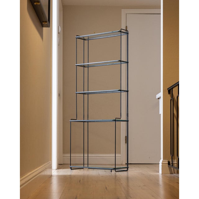 Dimensions: 24"W × 11.75"D × 59"H Shelf depths: Lower two 11 3/8"D; upper three 7 3/8"D Sculptural “Isocèle” étagère...