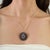 Crafted in 925 sterling silver, this striking medallion pendant features 11 carats of natural blue sapphires accented by...
