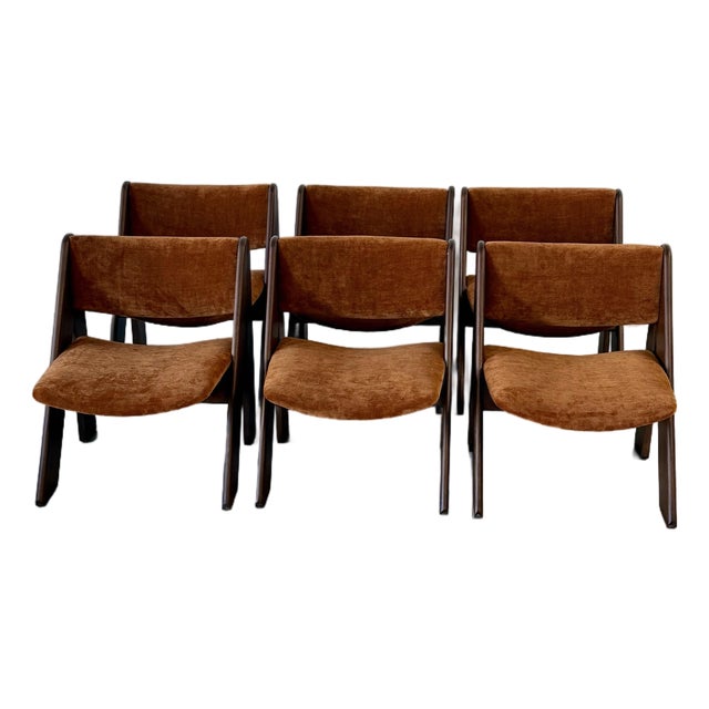 Gigi Sabadin designed his "Esse" chairs for Stilwood in 1973, bending a single sheet of plywood into a continuous S-curve...