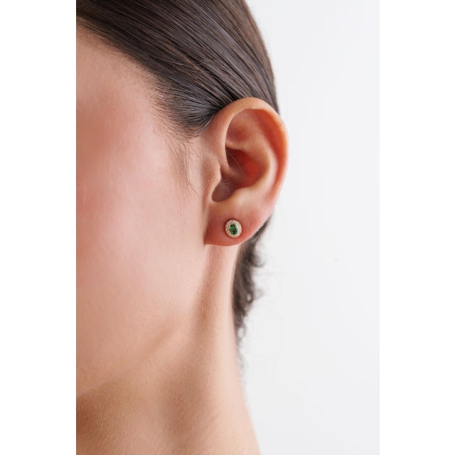 These elegant stud earrings feature 0.31 ct oval-cut emerald, set in 14k yellow gold. Each emerald measures 4 × 3 mm, each...