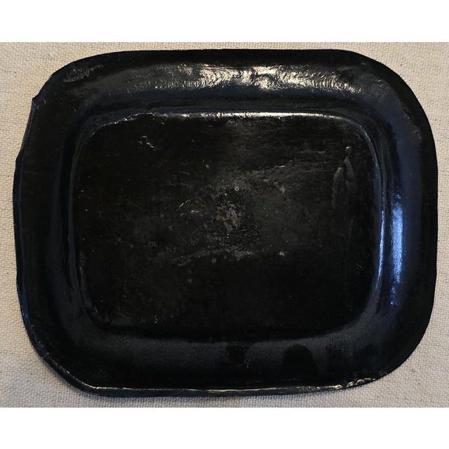 This is a charming small antique toleware tray, likely dating to the 19th century, featuring a hand-painted floral motif...