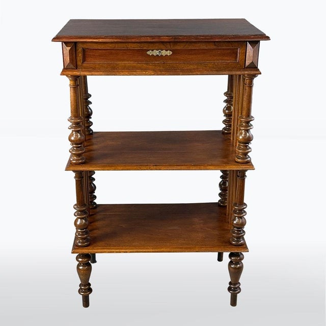 A charming wooden étagère in the Historicist style, featuring turned columns and a drawer in the top section. with three...