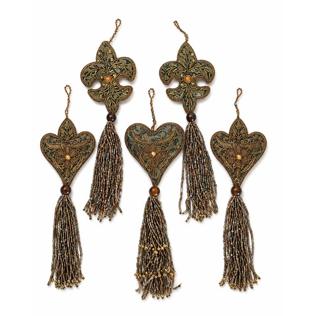 Ornate set of six decorative holiday ornaments featuring three heart designs and three fleur-de-lis designs, richly...