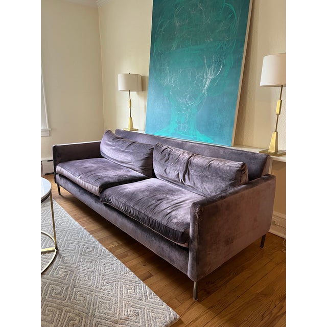 This sofa from the Cobble Hill collection boasts a rich light purple velvet upholstery, adding a touch of sophistication...