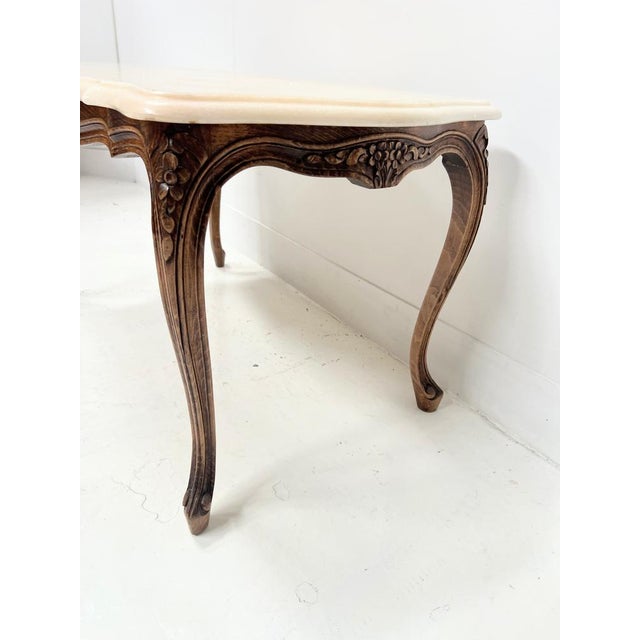Louis xv style coffee table in stained beechwood four cabriole legs the apron is carved with flowers on all four sides...