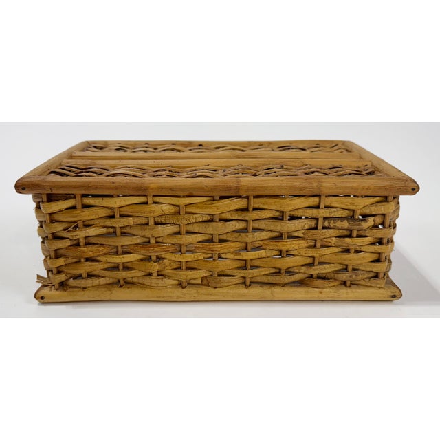 Vintage woven rattan and wood tissue box cover. Sits atop long narrow tissue box. Natural age wear.