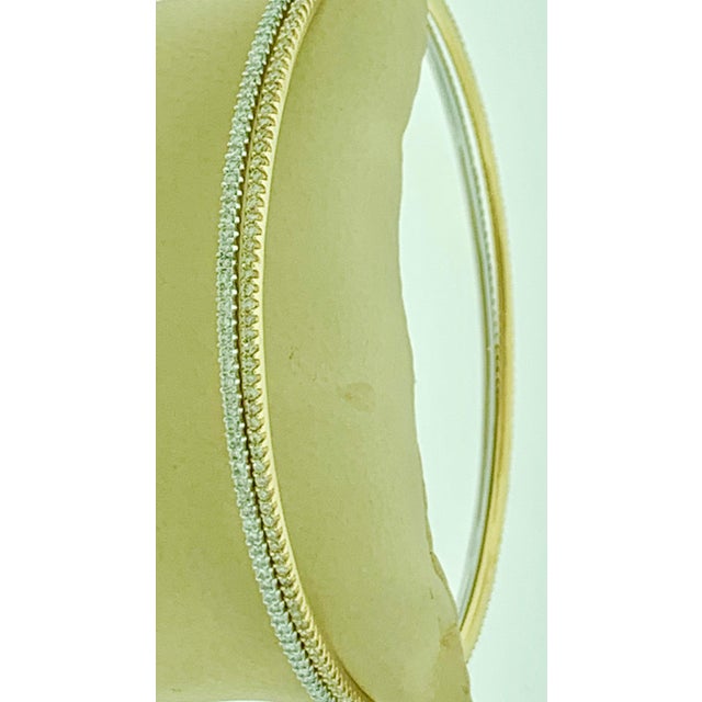 The Tesora Contemporary Yellow &amp; White 18 Karat Gold &amp; Diamond Bangle Bracelet is a beautiful piece of jewelry...