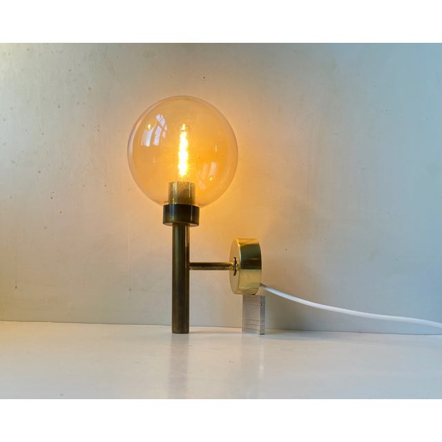 Sperical wall light in brass and hand-blown smoke glass. Designed by Hans Agne Jakobsson and manufactured by Markaryd AB...