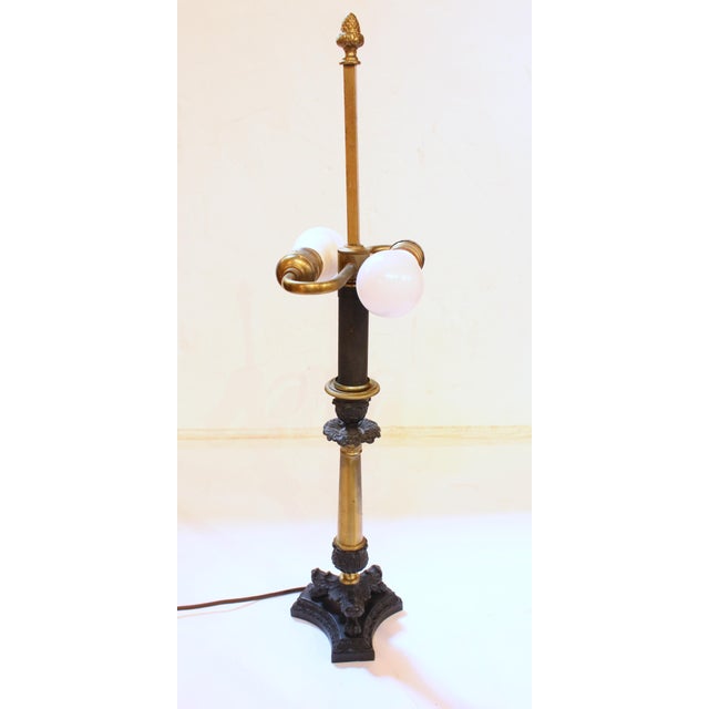 Mid-20th century French tole shaded cast iron & brass table lamp. Empire taste with tri-form base, acanthus leaf with ball...