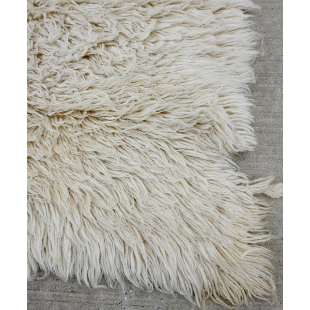 Natural fibers complete this wool Flokati rug from the midcentury era. These handmade rugs were produced for daily use by...