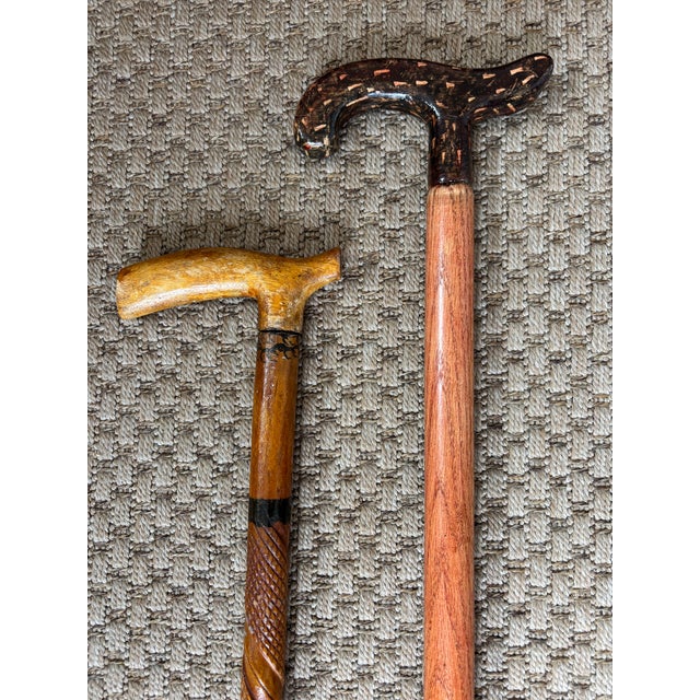 Vintage pair of estate walking canes, each with their own rustic folk art features. An excellent pair to add to or to...