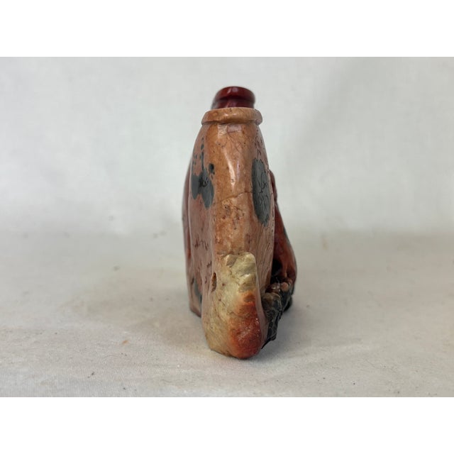 This carved double vase is likely Chinese. It depicts two animals eating food with flowers in the background. The vase is...