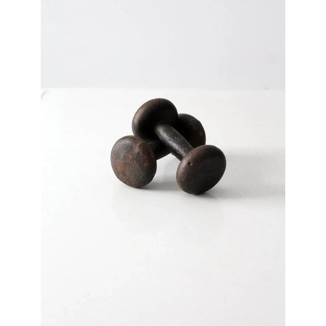 Pair of vintage 5 lb hand weights crafted from solid cast iron with a classic black finish and clearly defined weight...