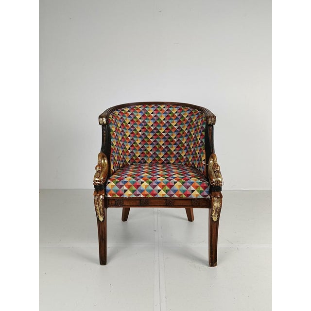 An armchair, circa 1940. The swan chair has a round wicker comb rail that continues into carved rosette arm joints,...