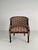 An armchair, circa 1940. The swan chair has a round wicker comb rail that continues into carved rosette arm joints,...