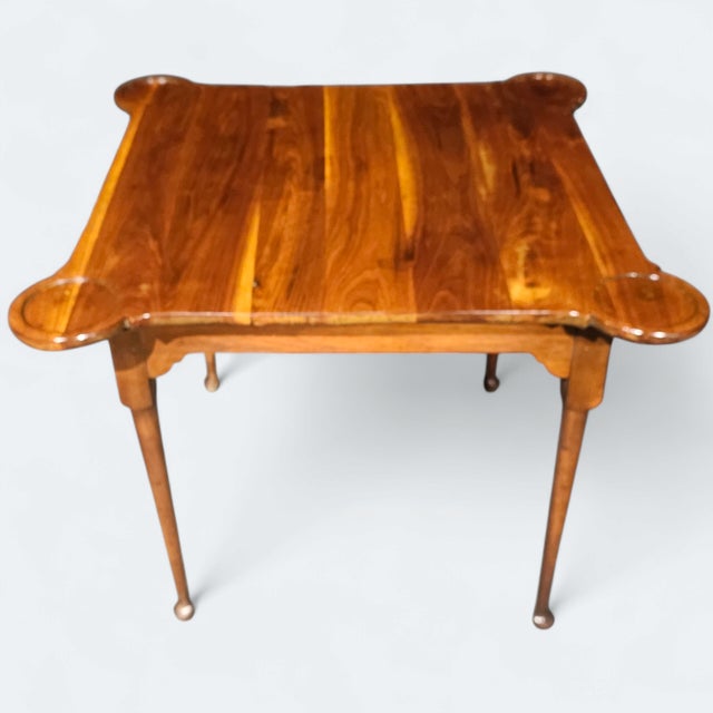 This antique Queen Anne Style Game Table is gorgeous, sophisticated, and elegant, with a rich and polished wooden surface...