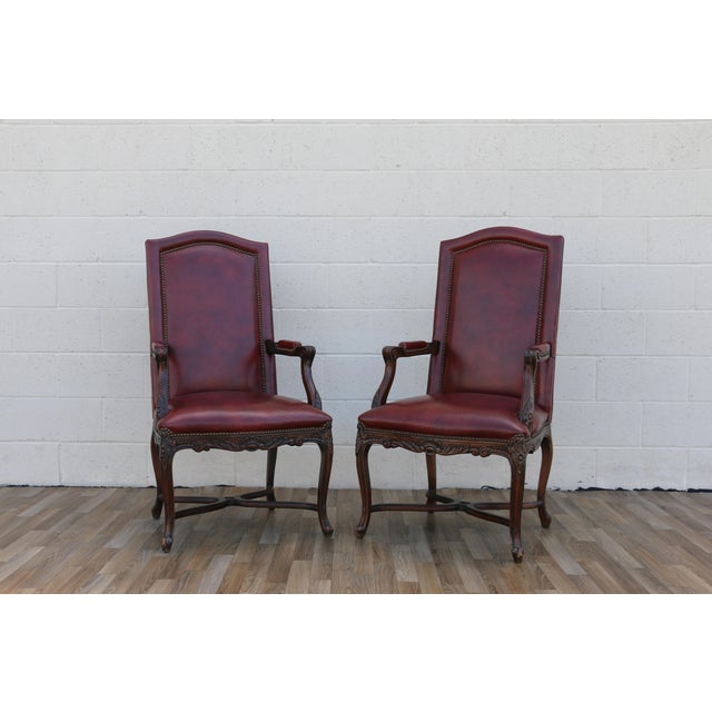 A handsome pair of vintage armchairs crafted in the English Regency style, showcasing refined proportions and timeless...