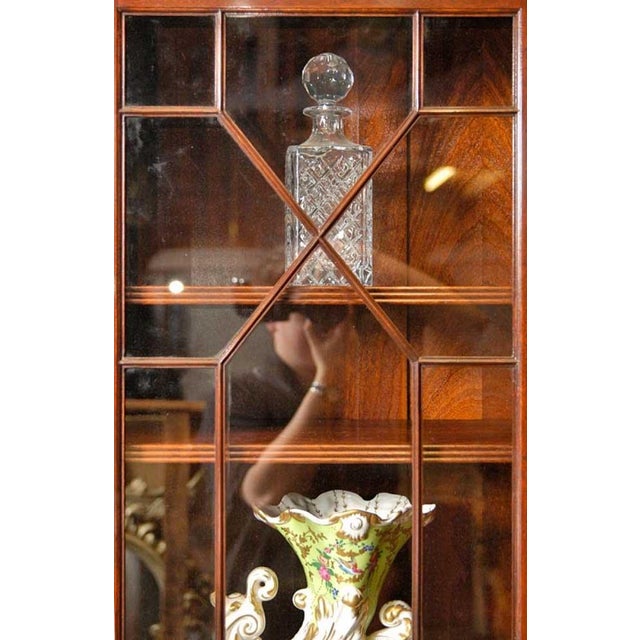 You are viewing a fantastic Sheraton style mahogany breakfront bookcase. The piece comes in two parts, the four door -...