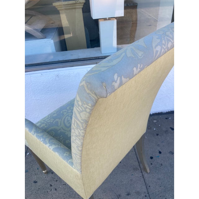 Beautiful Fortuny Fabric upholstered arm dining chair. Fabulous antique Silver Leaf finish. Contrast fabric applied to the...