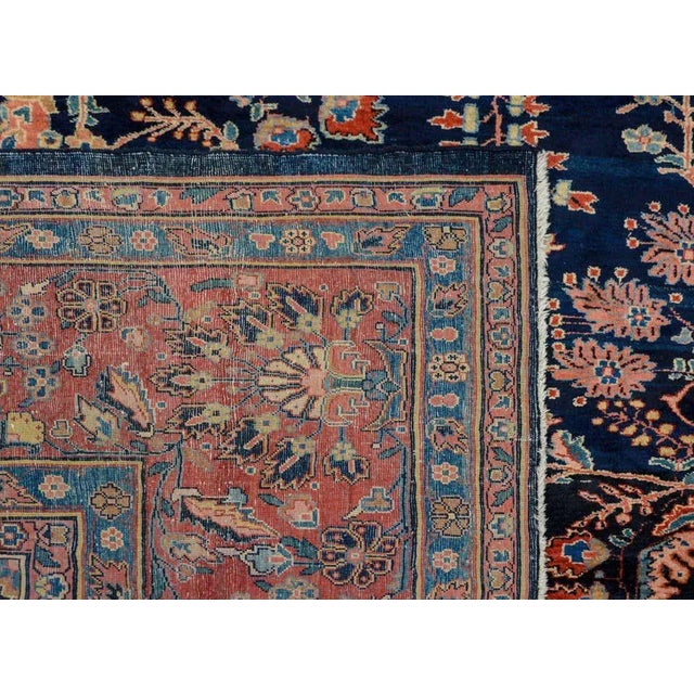 A fabulous early 20th century Persian Mohajeran rug with a bold all-over mirrored floral pattern with myriad varieties of...