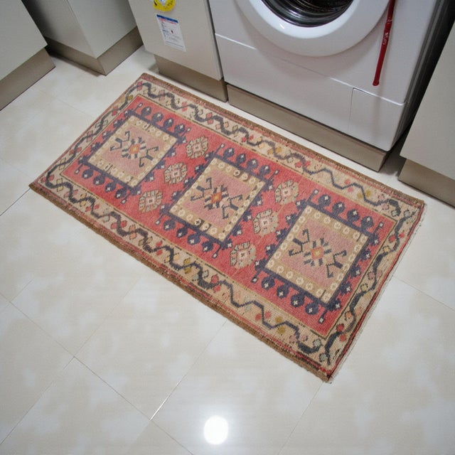 This vintage Turkish small rug presents a warm, softly faded palette with balanced geometric medallions that bring...