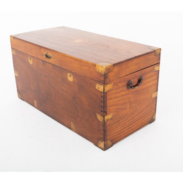 Handsome military campaign trunk crafted from aromatic camphor wood Featuring impressive brass strapwork double locks and...