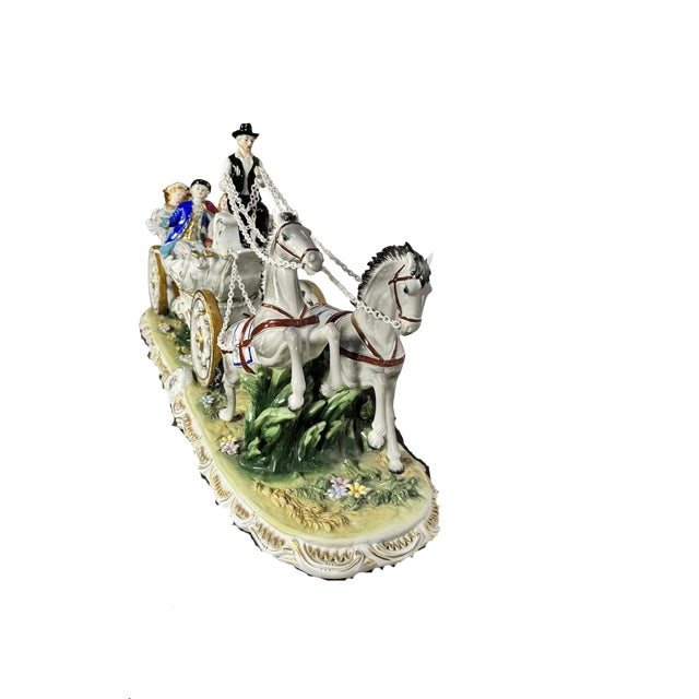 Impressive large hand-painted porcelain carriage group in the Dresden tradition. Two rearing dapple-grey horses in red...