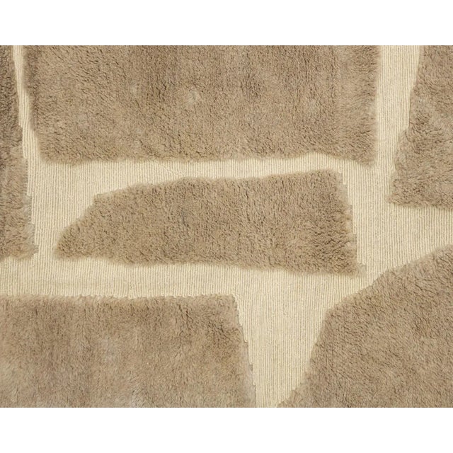 Elegant hand-knotted wool rug with a handwoven geometric pattern in Ivory on a Velvet Fawn backdrop, plush comfort with...