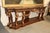 This monumental French console table is a stunning example of 19th-century craftsmanship, featuring gilded walnut and a...