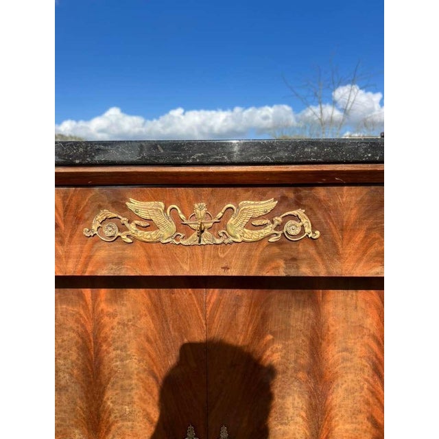 Spectacular French antique Empire sideboard made of flam mahogany, The wood has been finished with a lustrous French...
