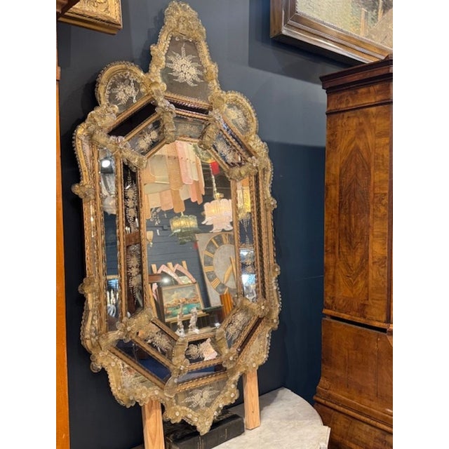 Very fine mid 20th century Venetian mirror. Featuring and octagonal shape with etched glass and gold flowers. An elegant...