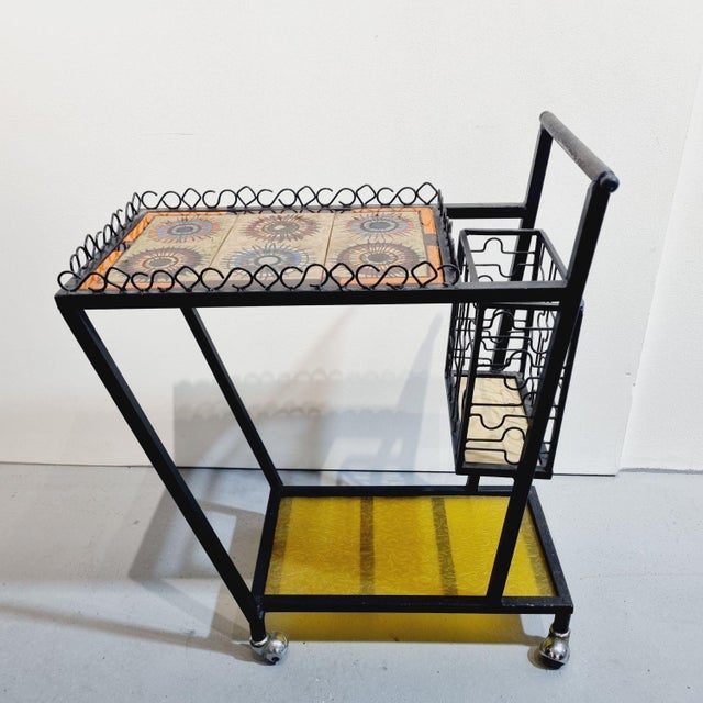 Vintage mid-century modern bar cart / serving trolley with a wrought iron frame and tiled top. Featuring characteristic...