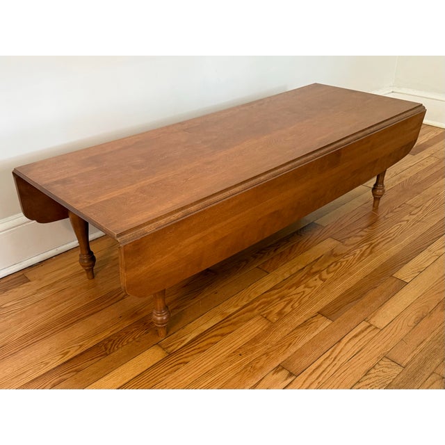 1950s Early American-style Ethan Allen by Baumritter maple drop-leaf coffee table. Before the company changed its name to...