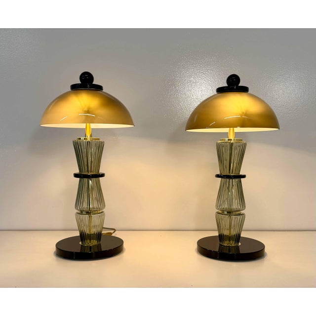 Elegant pair of Italian table lamps produced in Murano during the 2000s. The lamps feature large hand-blown smoked grey...