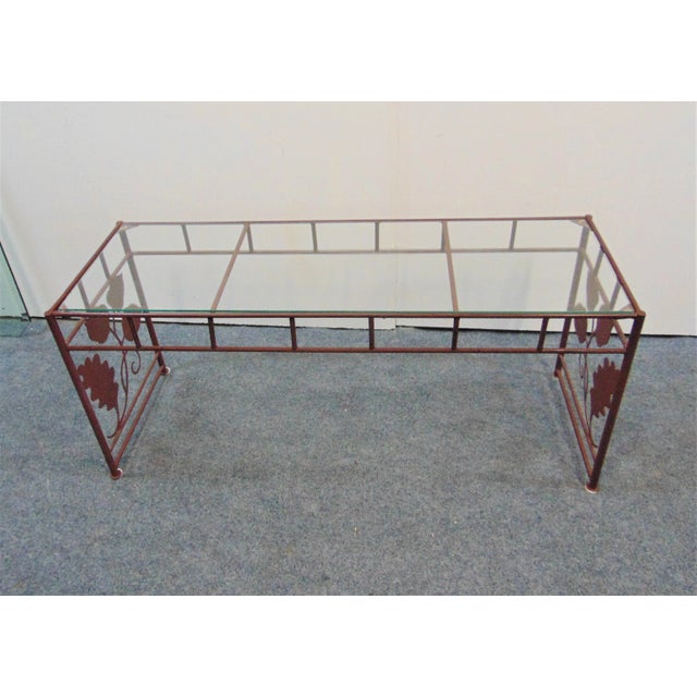 Modern design coffee table , made of steel rod with cut out leaf designs on each end, burgundy painted finish , glass...