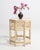 A decorative side table influenced by Chinoiserie design, featuring delicate detailing and a protective glass top. The...