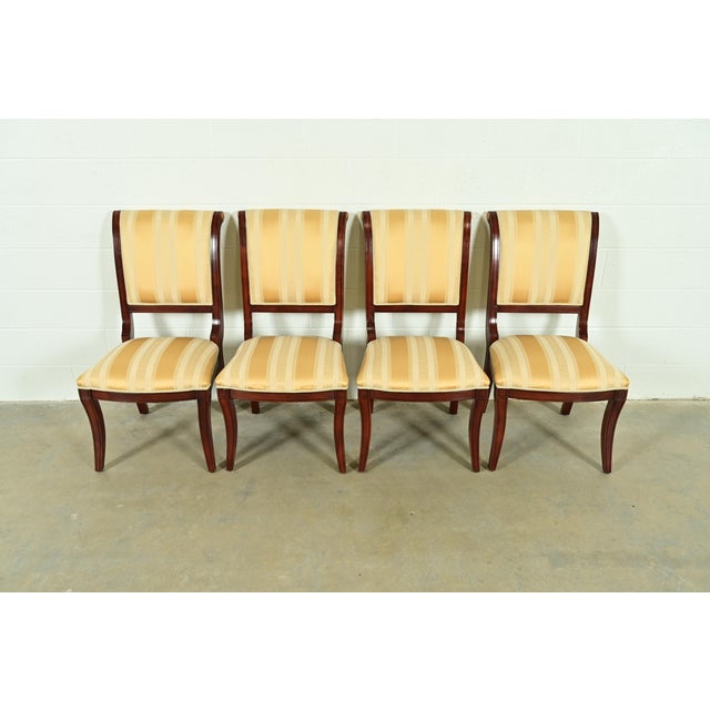 A gorgeous set of four Regency style dining chairs In the manner of Baker Furniture USA, Circa 1980s Carved mahogany...