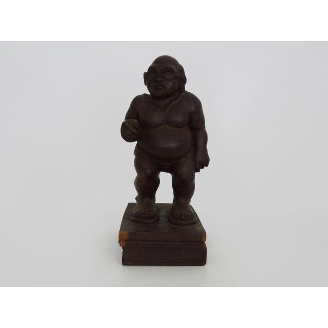 Grotesque exotic wood sculpture of a man in sunglasses and flip-flops. 80s. Botero style Superb exotic wood sculpture...