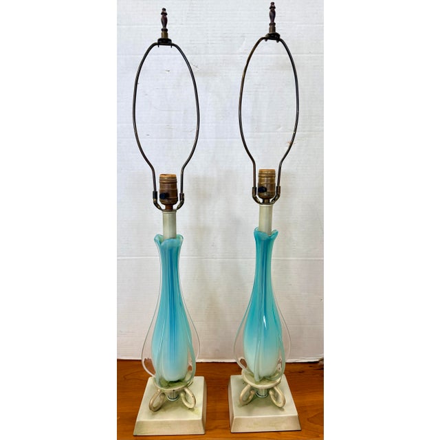 A beautiful pair of vintage Murano style glass table lamps featuring elegant handblown forms in soft turquoise blue cased...