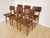 Cute vintage dining chairs are made in mid-century style from wooden base and brown leather seat and backrest. Chairs were...