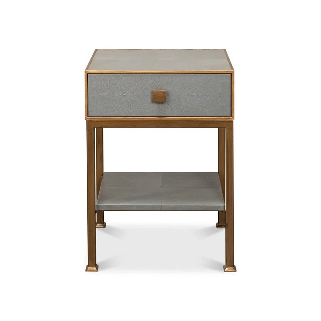 A streamlined design with its sleek embossed leather framed in a lustrous gilt finish. The single drawer, adorned with a...