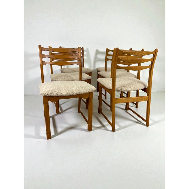 Set of six Danish oak dining chairs from the 1960s, attributed to Henning Kjærnulf. The chairs display many of the...