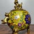 This charming incense burner is crafted from a bronze body and richly decorated with cloisonné enamel. The vessel features...