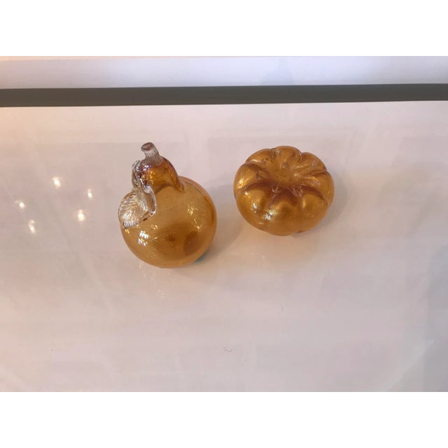 Pair of handblown Murano glass decorative paperweights. They're gold with internal gold flecking and they're very...