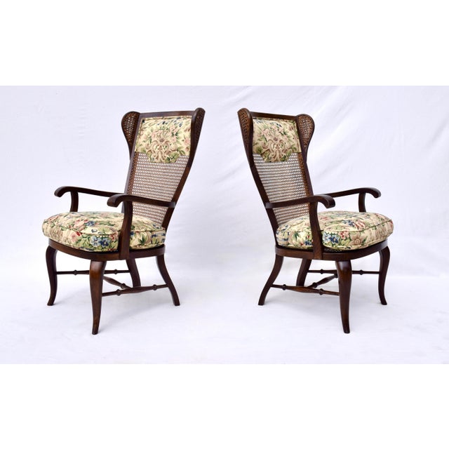 An impressive pair of caned wing back chairs with original upholstery & goose down filled notched custom cushions. Italian...
