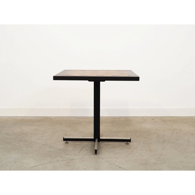 The table was made in the 1970s, Danish production. The table top is covered with exotic wood veneer. The legs are made of...